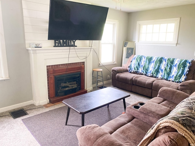 6913 E Jackson St, Muncie, IN 47303 - carpeted living area featuring a fireplace and baseboards