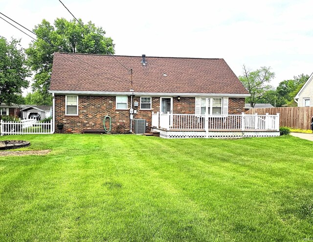 318 W Jefferson St, Chandler, IN 47610 - rear view of house featuring a wooden deck, roof with shingles, brick siding, and central air condition unit