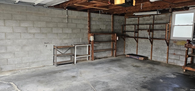 318 W Jefferson St, Chandler, IN 47610 - garage featuring concrete block wall and a garage door opener
