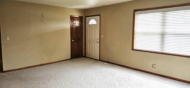 318 W Jefferson St, Chandler, IN 47610 - foyer entrance featuring light carpet and baseboards