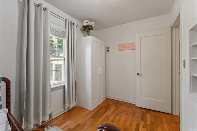 unfurnished bedroom with light wood-style flooring