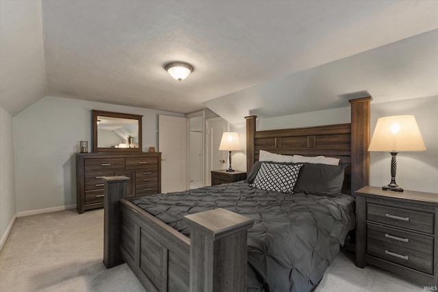 bedroom with light carpet, vaulted ceiling, and baseboards