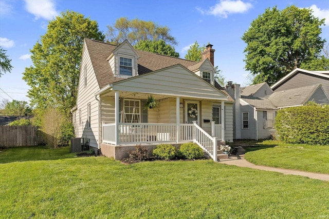 cape cod-style house with a porch and roof with shingles
