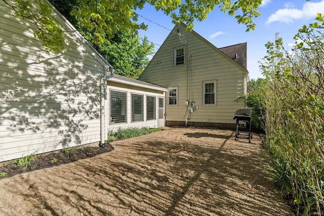back of house with roof with shingles