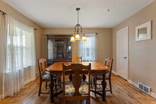 dining room with light wood-style flooring and baseboards