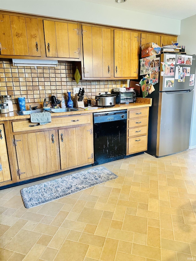 2912 W Twickingham Dr, Muncie, IN 47304 - kitchen featuring black dishwasher, freestanding refrigerator, tasteful backsplash, and light countertops
