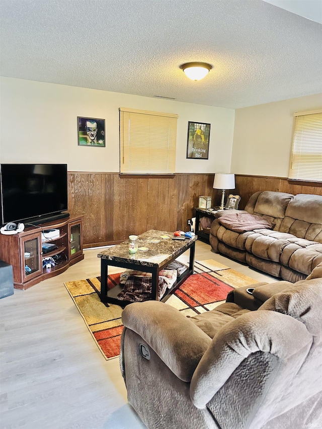 2912 W Twickingham Dr, Muncie, IN 47304 - living room with wainscoting, wood finished floors, wooden walls, and a textured ceiling