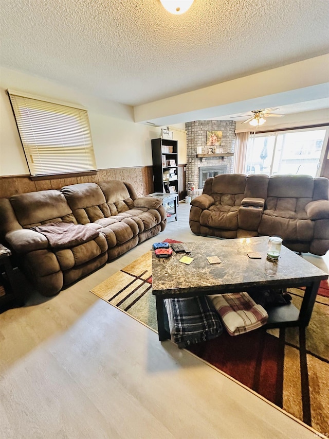 2912 W Twickingham Dr, Muncie, IN 47304 - living room with wainscoting, a textured ceiling, and a brick fireplace