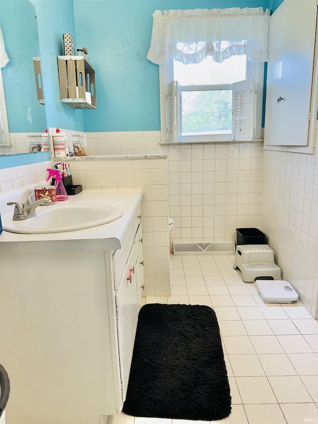 2912 W Twickingham Dr, Muncie, IN 47304 - bathroom with tile walls, vanity, and tile patterned floors