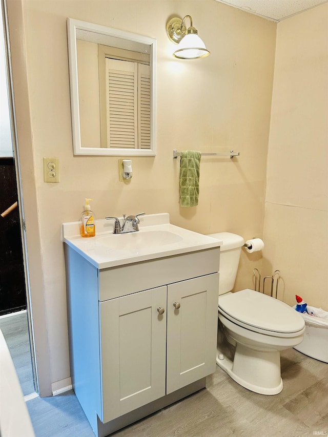 2912 W Twickingham Dr, Muncie, IN 47304 - bathroom featuring wood finished floors, toilet, and vanity