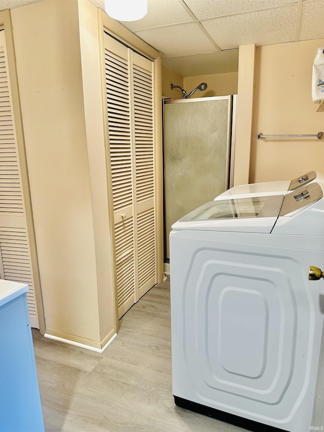 2912 W Twickingham Dr, Muncie, IN 47304 - full bathroom featuring washer / dryer, a closet, wood finished floors, a paneled ceiling, and a shower stall