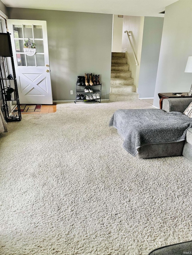 2912 W Twickingham Dr, Muncie, IN 47304 - living room featuring carpet floors, stairway, and baseboards