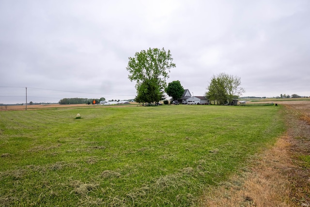 view of green lawn featuring a view of countryside