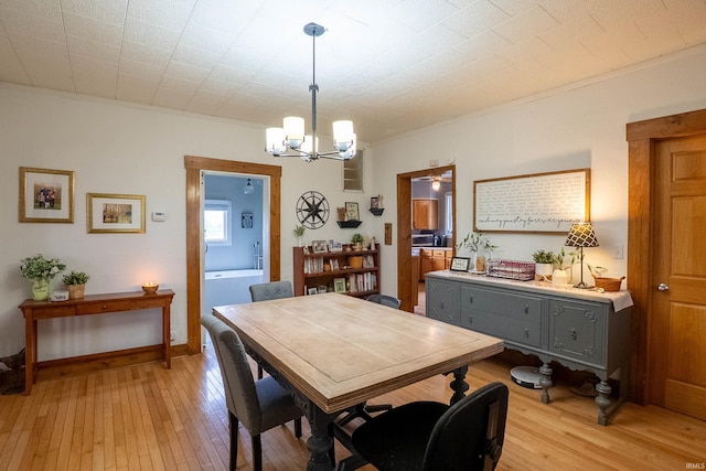 dining room with a chandelier and light wood-type flooring