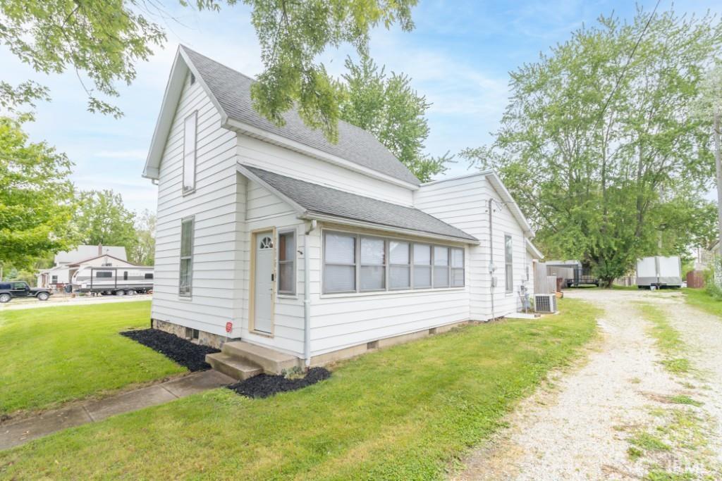 108 N Maple St, Sulphur Springs, IN 47388 - traditional-style house featuring entry steps, driveway, roof with shingles, central AC unit, and a front yard