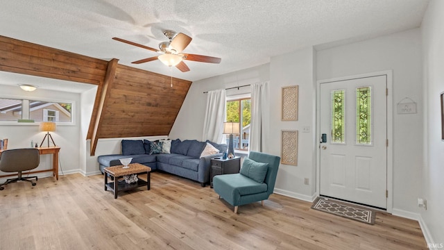 11381 NE Wawasee Dr, Syracuse, IN 46567 - living area featuring a ceiling fan, light wood finished floors, a textured ceiling, and baseboards