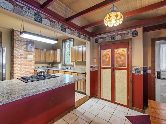 422 E Washingtion St, Oakland City, IN 47660 - kitchen featuring gas cooktop, a sink, light tile patterned flooring, beam ceiling, and pendant lighting