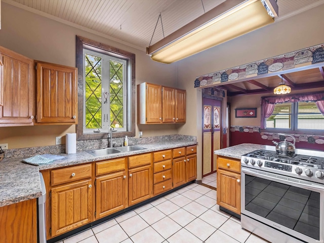 422 E Washingtion St, Oakland City, IN 47660 - kitchen with stainless steel gas range oven, a sink, healthy amount of natural light, and light tile patterned floors