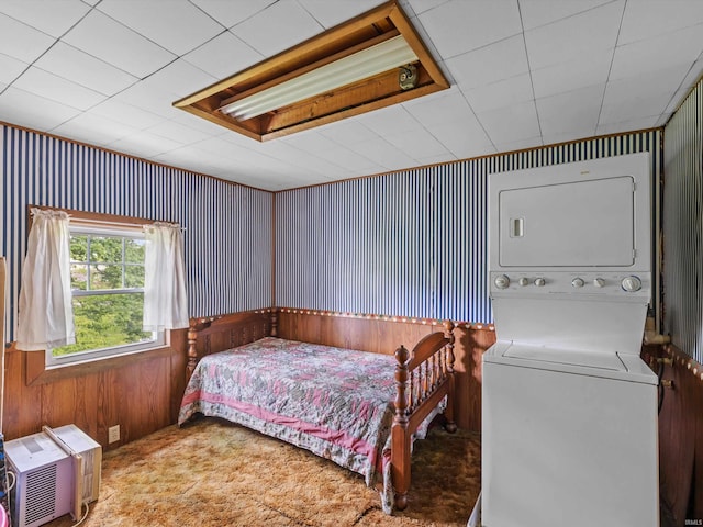 422 E Washingtion St, Oakland City, IN 47660 - bedroom featuring stacked washer and clothes dryer, wood walls, and carpet floors