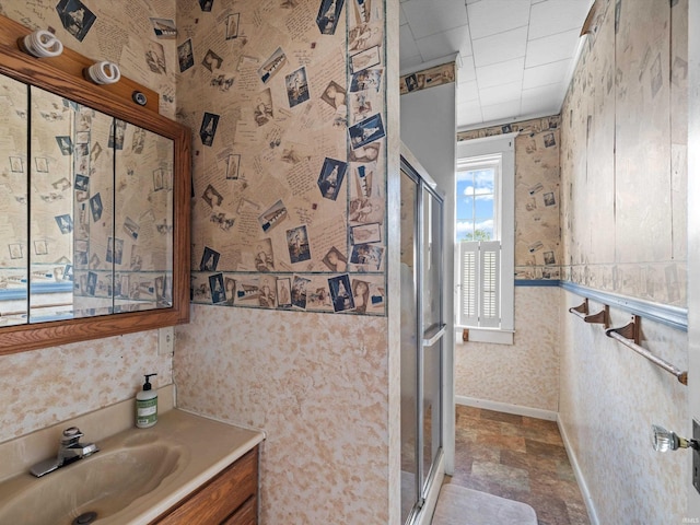 422 E Washingtion St, Oakland City, IN 47660 - full bath featuring wallpapered walls, a stall shower, vanity, and baseboards