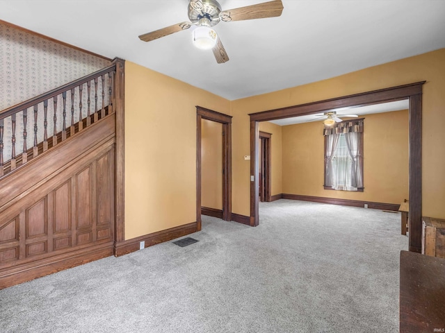 422 E Washingtion St, Oakland City, IN 47660 - unfurnished room featuring a ceiling fan, carpet, baseboards, and stairway