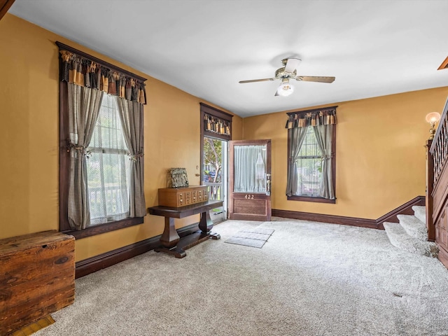 422 E Washingtion St, Oakland City, IN 47660 - foyer entrance featuring carpet, baseboards, stairs, and a ceiling fan