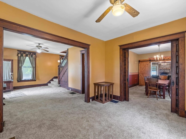 422 E Washingtion St, Oakland City, IN 47660 - carpeted empty room featuring a ceiling fan, stairs, baseboards, and a barn door