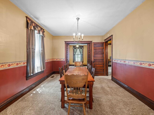 422 E Washingtion St, Oakland City, IN 47660 - carpeted dining room featuring a chandelier