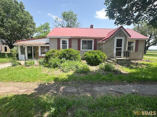 128 S Main St, Griffin, IN 47616 - ranch-style house featuring a chimney and metal roof