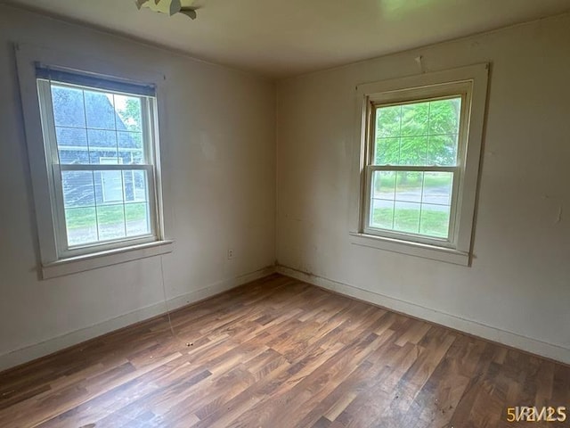 128 S Main St, Griffin, IN 47616 - unfurnished room with plenty of natural light, wood finished floors, and baseboards