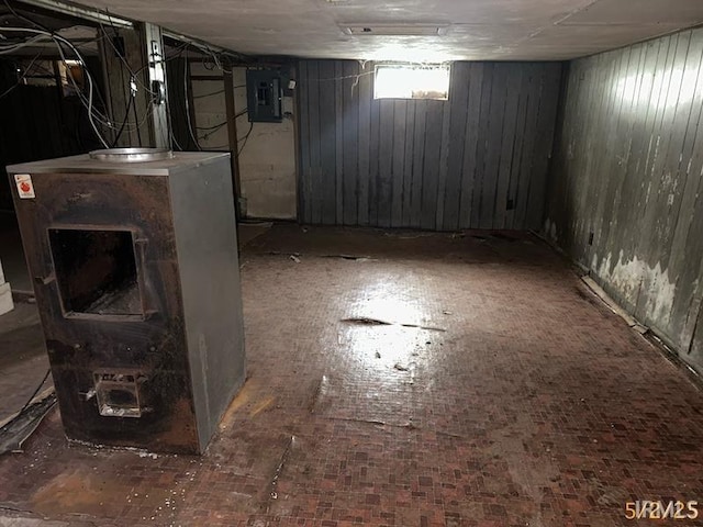 128 S Main St, Griffin, IN 47616 - below grade area featuring electric panel, wood walls, and brick patterned floors
