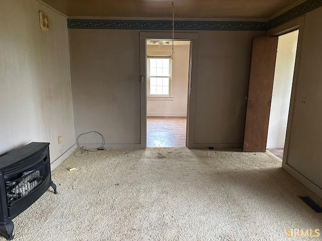 128 S Main St, Griffin, IN 47616 - unfurnished living room with carpet, crown molding, and heating unit