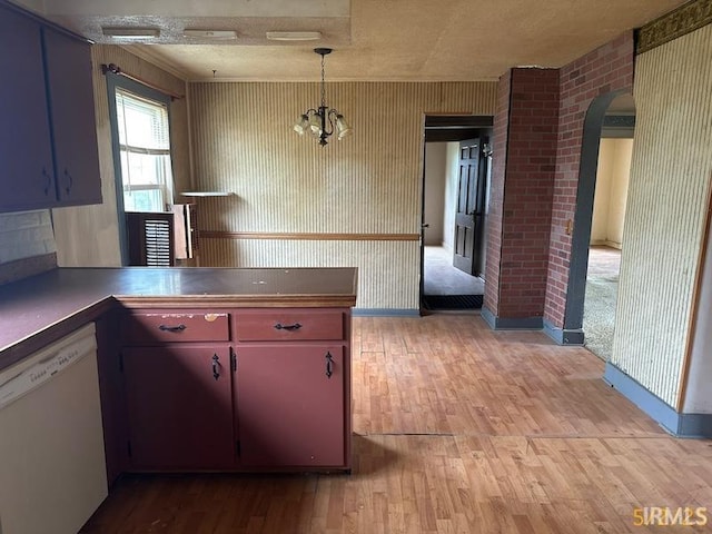 128 S Main St, Griffin, IN 47616 - kitchen featuring white dishwasher, arched walkways, light wood finished floors, and pendant lighting