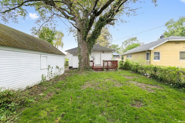 view of grassy yard featuring a wooden deck
