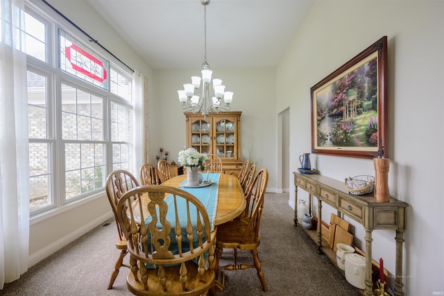 11608 Boggs W Cir, Loogootee, IN 47553 - carpeted dining space with a chandelier and baseboards
