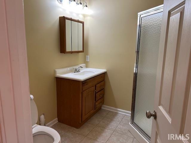 1221 N Lindbergh Dr, Bloomington, IN 47404 - full bath with toilet, a stall shower, tile patterned flooring, vanity, and baseboards