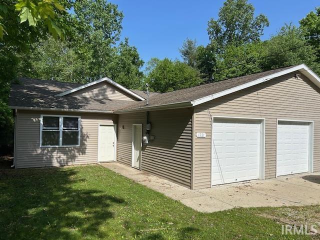 1221 N Lindbergh Dr, Bloomington, IN 47404 - ranch-style home with a front yard, roof with shingles, and an attached garage