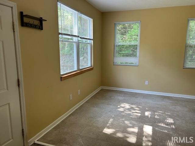 1221 N Lindbergh Dr, Bloomington, IN 47404 - spare room featuring baseboards