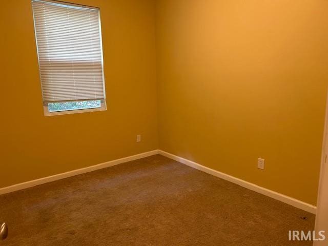1221 N Lindbergh Dr, Bloomington, IN 47404 - unfurnished room featuring dark carpet and baseboards