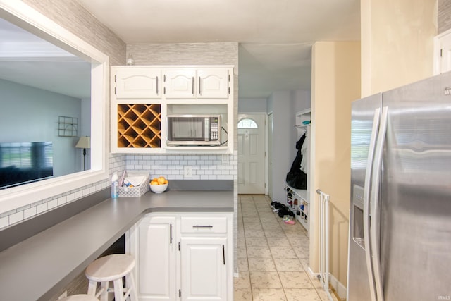 1818 Chochtimar Trl, Fort Wayne, IN 46808 - kitchen featuring appliances with stainless steel finishes, white cabinets, and decorative backsplash