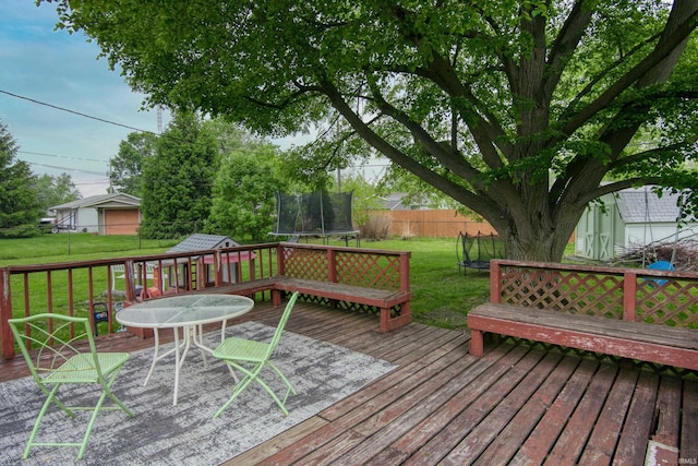 1818 Chochtimar Trl, Fort Wayne, IN 46808 - wooden deck featuring a trampoline, a shed, and an outbuilding