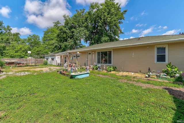 back of house featuring a garden