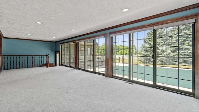 spare room with ornamental molding, carpet flooring, a textured ceiling, and recessed lighting