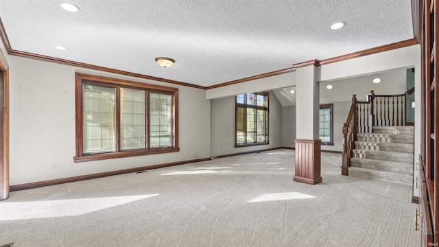 unfurnished living room with ornamental molding, carpet, baseboards, recessed lighting, and a textured ceiling