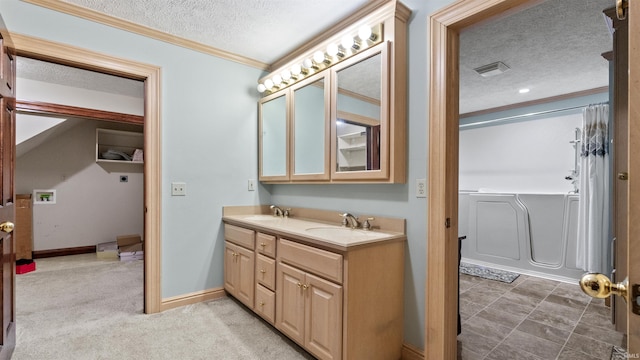 full bath with a textured ceiling, ornamental molding, double vanity, and baseboards