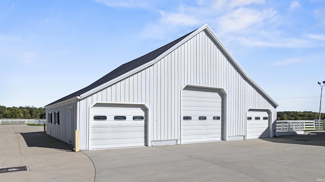 detached garage featuring fence