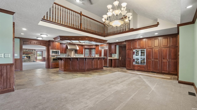 kitchen featuring stainless steel appliances, a chandelier, light countertops, a breakfast bar, and light carpet