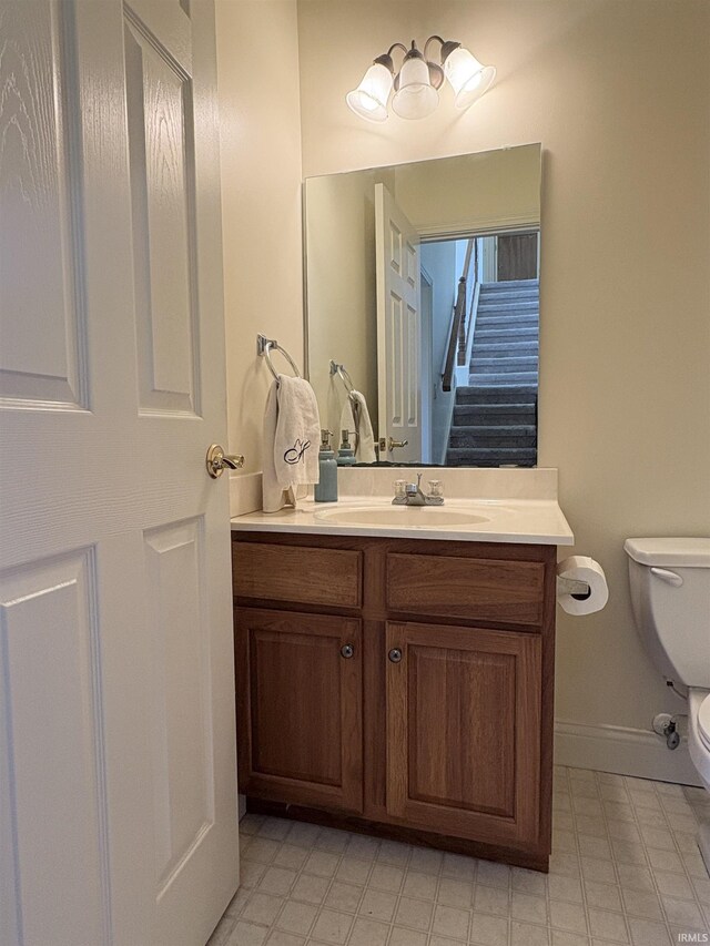 1804 Canyon Creek Dr, Lafayette, IN 47909 - half bathroom featuring toilet, vanity, baseboards, and tile patterned floors