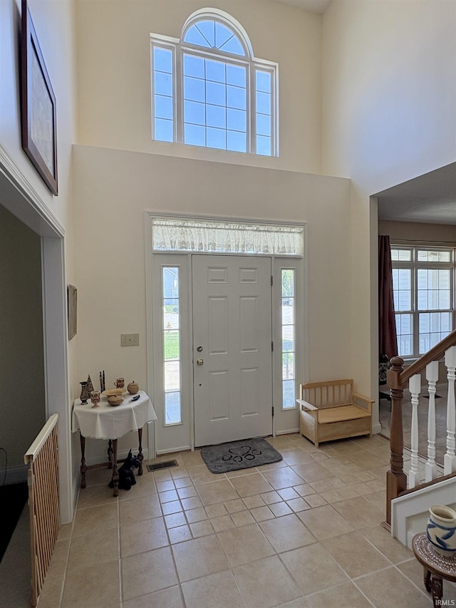 1804 Canyon Creek Dr, Lafayette, IN 47909 - foyer featuring a towering ceiling, light tile patterned floors, and stairs