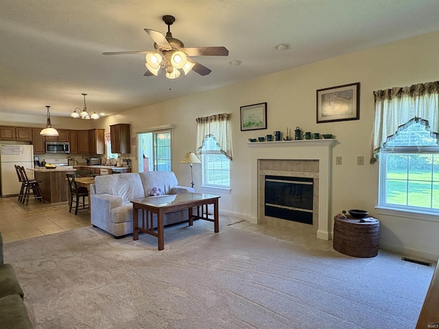 1804 Canyon Creek Dr, Lafayette, IN 47909 - living area featuring light colored carpet, healthy amount of natural light, a ceiling fan, and a tile fireplace